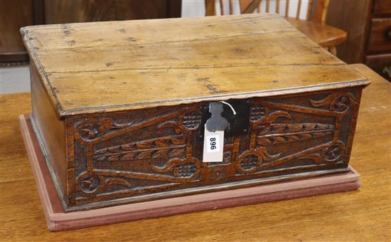 A 17th century carved oak bible box, dated 1691, carved with the initials M.G. W.58cm